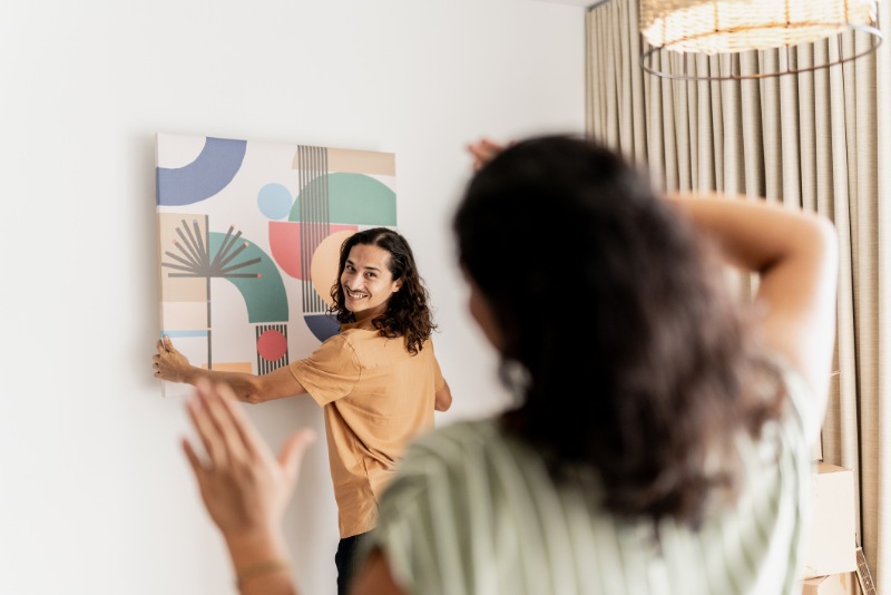 couple putting up painting