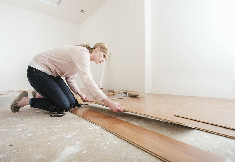 Woman Installing Laminate Flooring