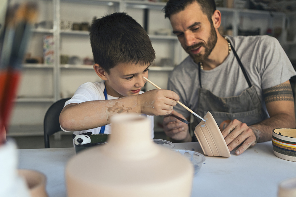 Father and son working on art